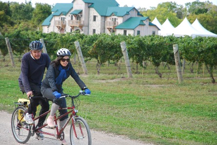 Cyclists riding in front of winery