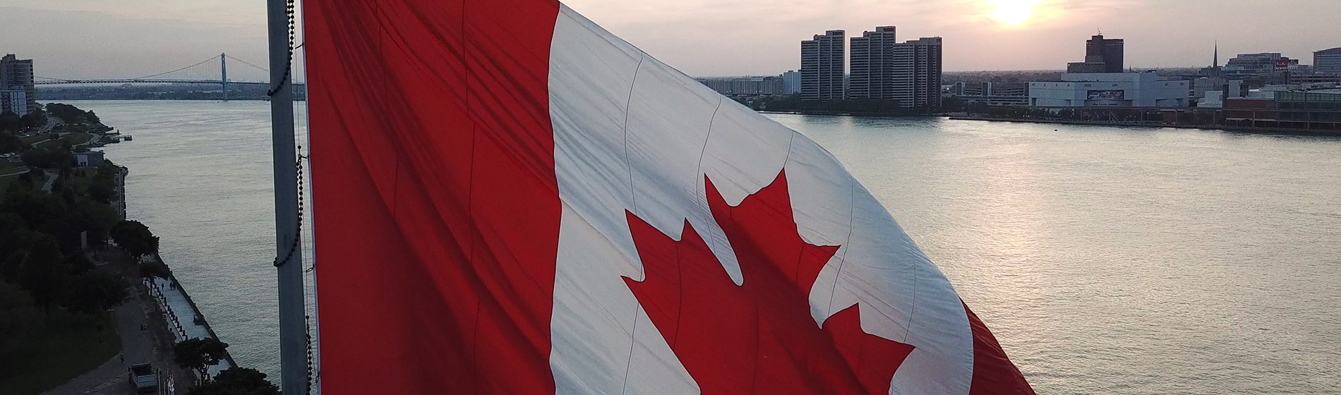 Aerial view of Canadian flag with Windsor and Detroit skyline in the background