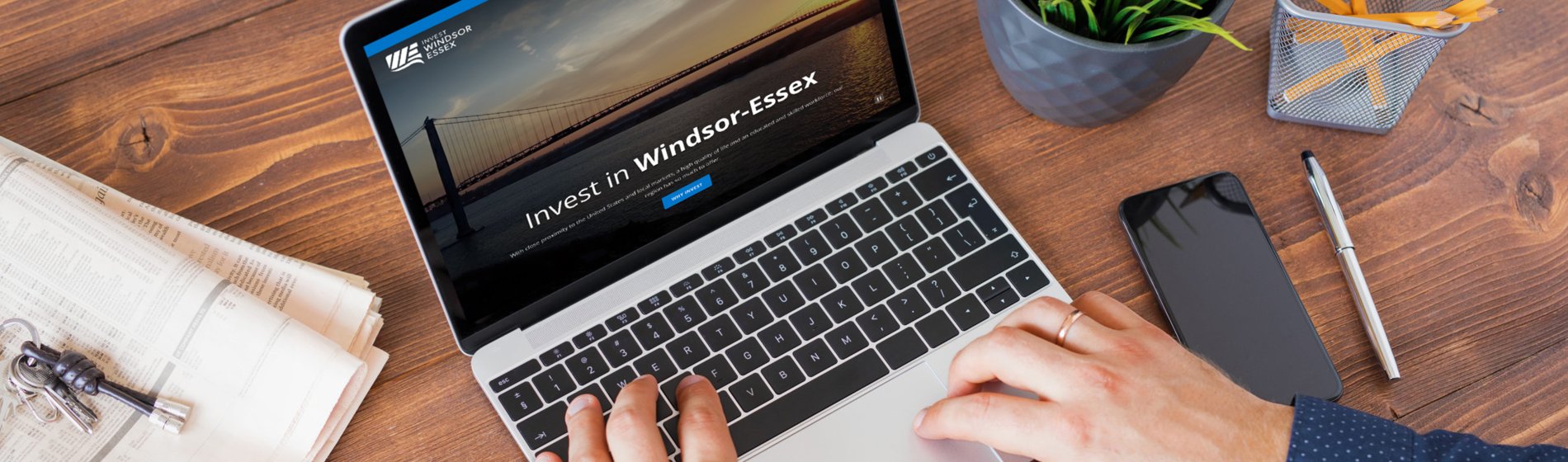 Person browsing Invest Windsor-Essex website on laptop